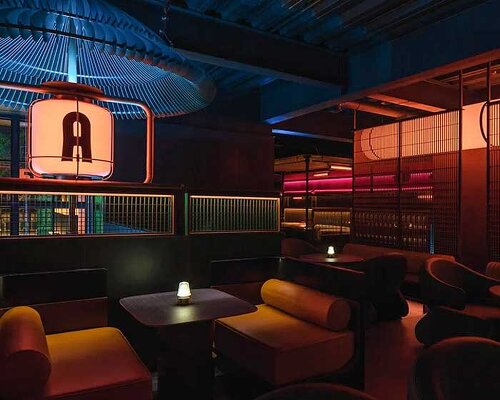 geometrical lines and pops of color create a tipsy night within retro pub in china