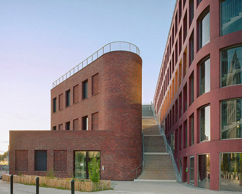 red brick and colored concrete unify raum’s mixed-use building in nantes