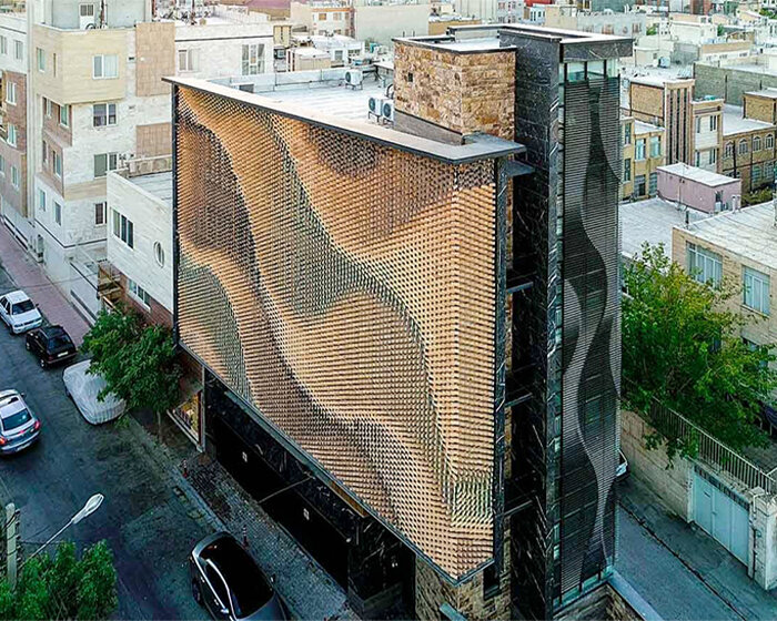 a rippling brick façade in iran offers privacy from onlookers without blocking natural light