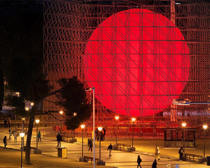 SpY cages huge luminous red sphere within scaffolding structure in madrid