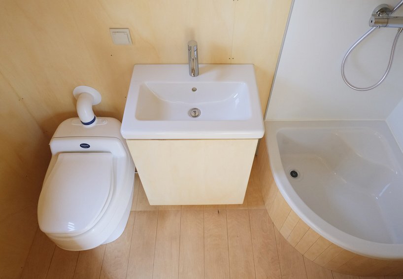 the minimal bathroom includes a composting toilet for off-grid living