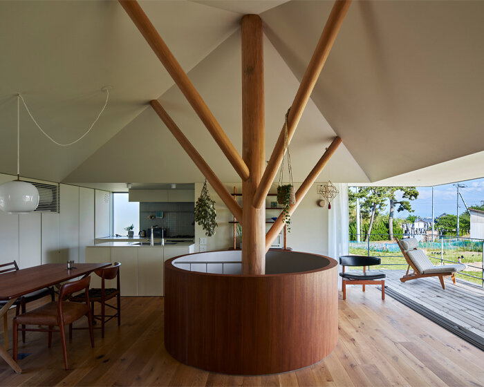 takeru shoji architects' half-sunken house in japan strongly connects to the open grasslands