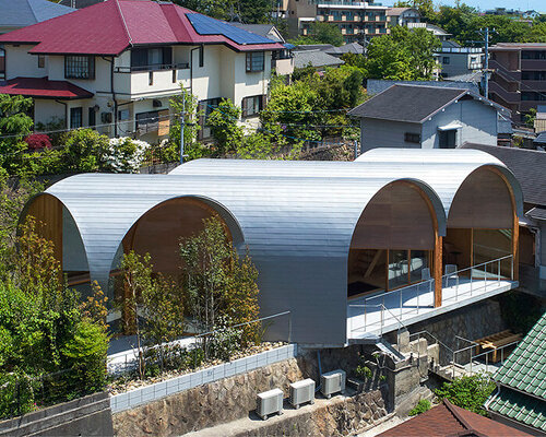 a series of tilted vaulted roofs tops wooden house by tomohiro hata in koyoen, japan