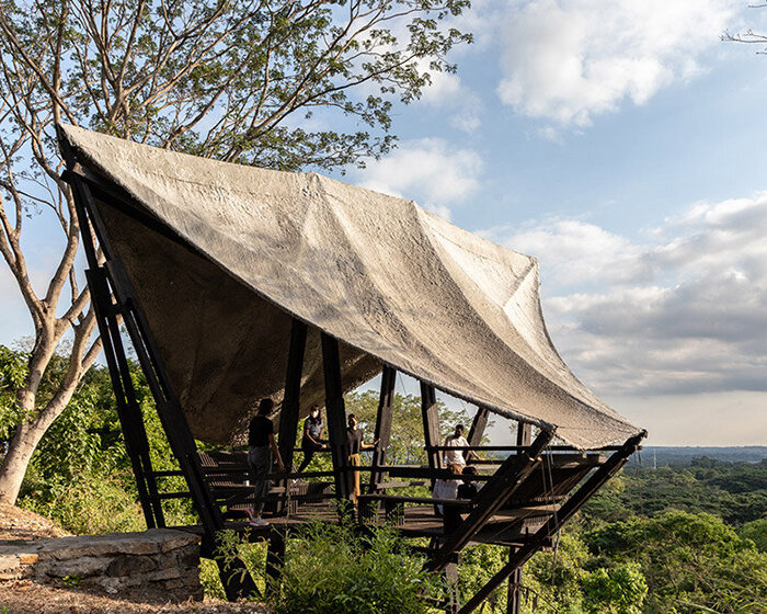 wooden 'mirador aula' is suspended above protected forest in ecuador