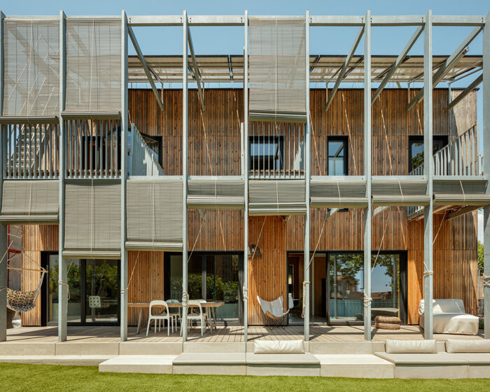 outside barcelona, SUMO architects wraps its BE house in an operable shading system