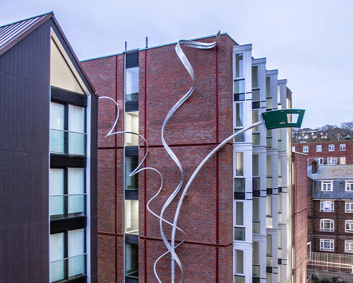 alex chinneck unveils 25-meter-high spiraling sculpture in brighton, uk