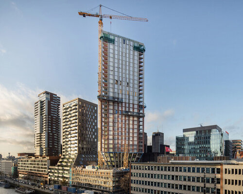 rotterdam's first triangular tower tops out in the city's maritime district