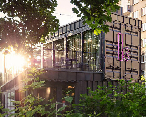 COLLARCH shapes café from gray recycled shipping containers in prague