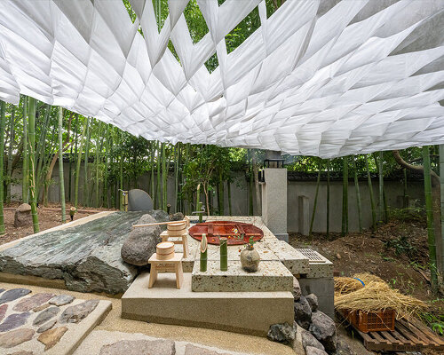 kengo kuma's interwoven pavilion hovers among bamboo grove in tokyo