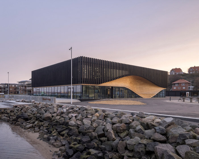 3XN honors denmark's ship-building heritage with the fluid facade of its 'klimatorium'