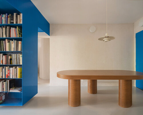 floating blue bookshelf centers BURR's conversion project in madrid