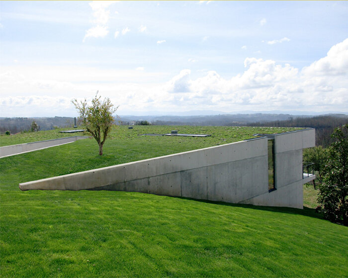  UTOPIA's concrete house gently digs into its greenery terrain in portugal