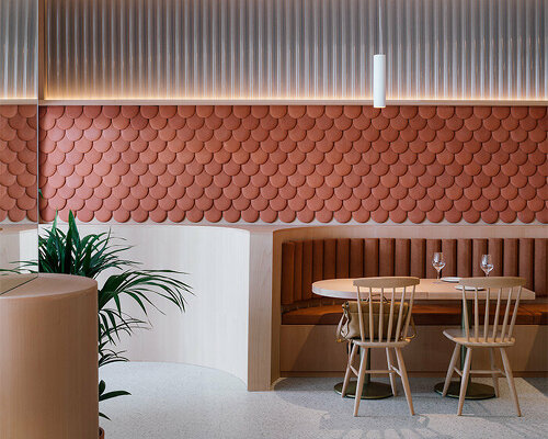 zooco estudio wraps restaurant interior in spain with clay scales and semi-transparent pipes