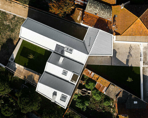 NU.MA completes a minimalist house of gable roofs in santa joana, portugal