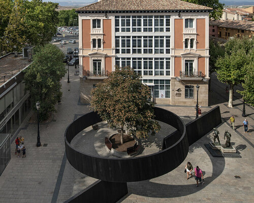 this installation cuts through a public square in spain with simple yet powerful gestures