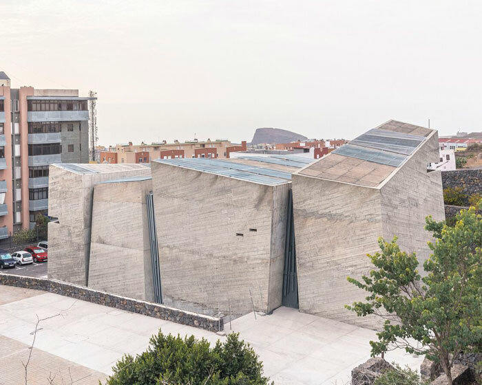 menis arquitectos' church on tenerife island is a cluster of monolithic stone blocks