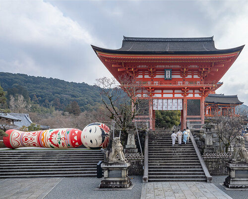 giant kokeshi doll welcomes visitors to historic kiyomizu-dera temple in kyoto