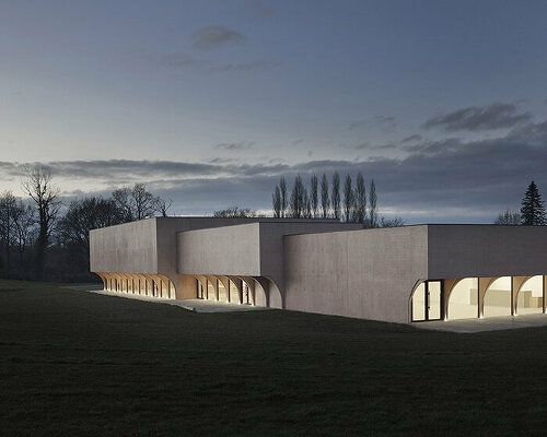 a series of half arches carve monolithic cultural center in france