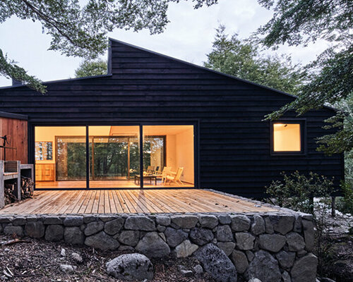 minimalistic cabin by hebra arquitectos emerges from a stone plinth in chile