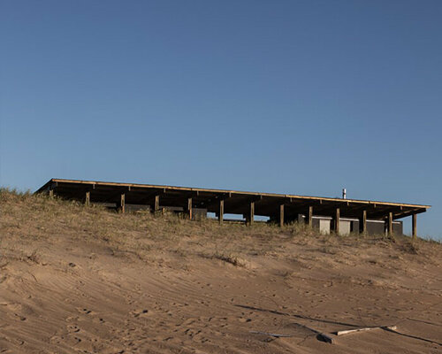 'punta rubia refuge' shielded by timber skeleton sits along coastline in uruguay