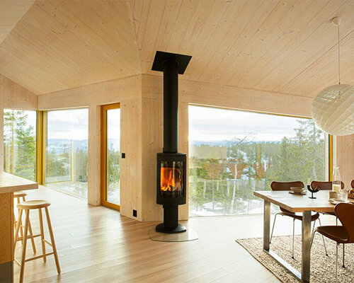 this timber-clad cabin in mountainous norway splits into three wings