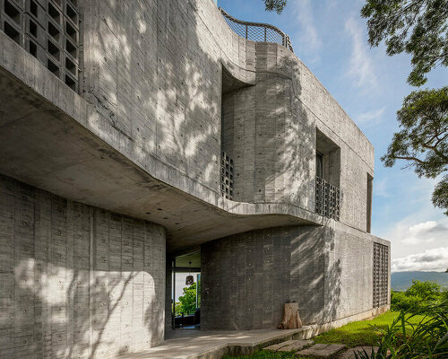 curvaceous concrete walls compose XRANGE architects' remote retreat in taiwan