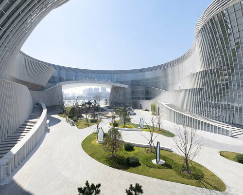 this undulating 'grand canal theater' by TJAD frames the lake of yangzhou