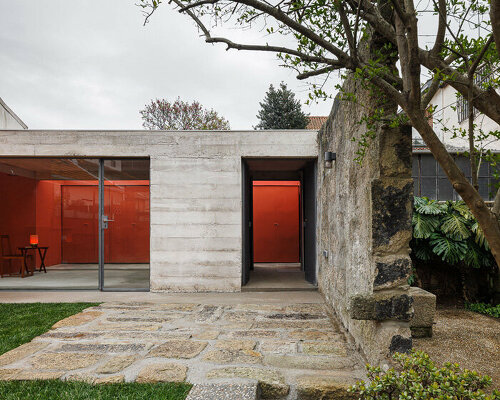 white concrete encloses josé pedro lima's bright red multi-use garden pavilion in portugal