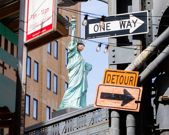 statue of liberty with emoji-inspired mask by paola pivi rises in the high line, NYC