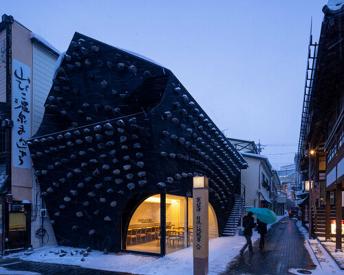 kengo kuma adds local stone to hot spring inn in kusatsu, japan