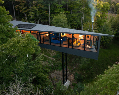 kariouk architects perches this m.o.r.e cabin atop stilts above the canadian forests