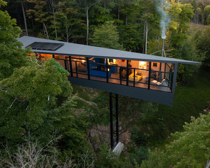 kariouk architects perches this m.o.r.e cabin atop stilts above the canadian forests