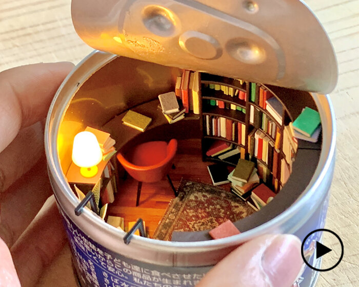 empty food can becomes portal to cozy, miniature reading room