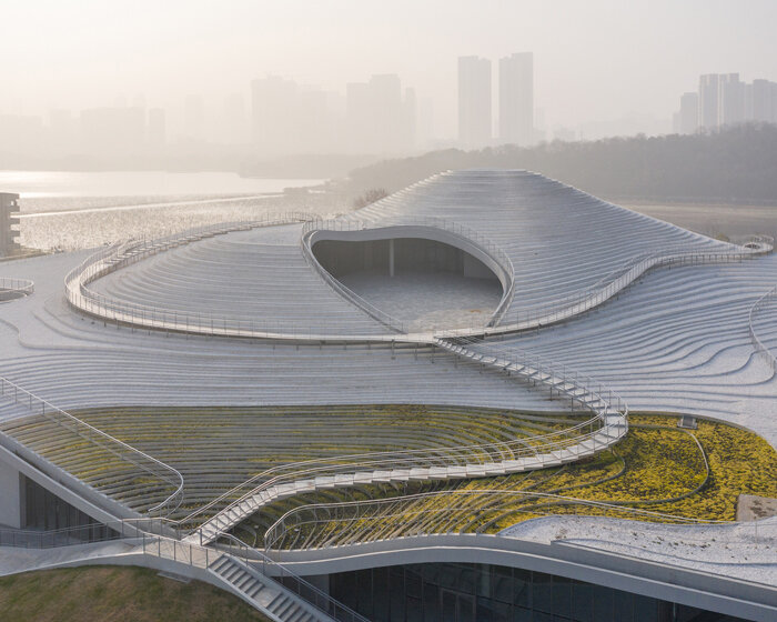 atelier deshaus tucks its qintai art museum beneath an undulating, stepped topography