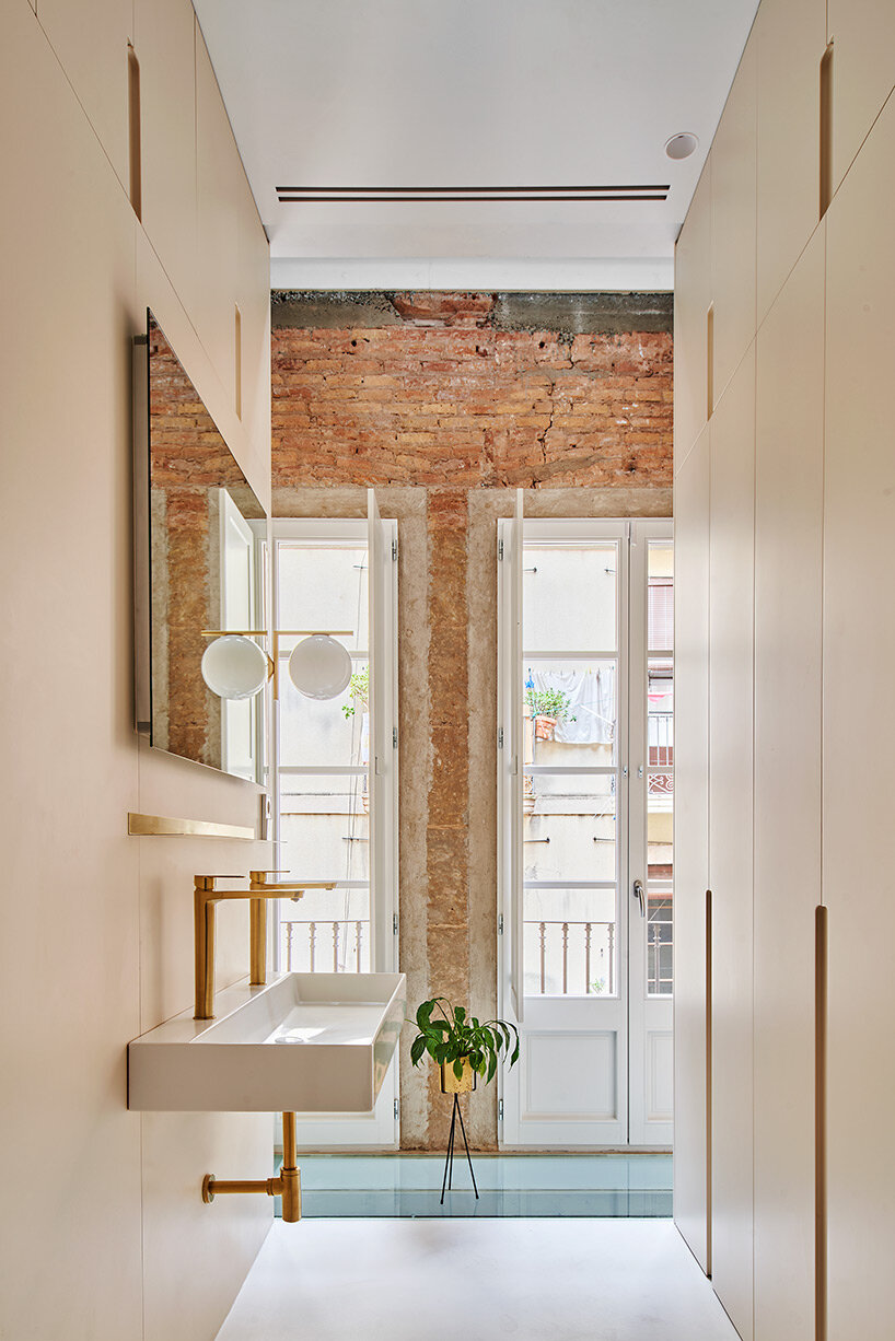 raúl sánchez installs brass kitchen to brick residential interior in  barcelona