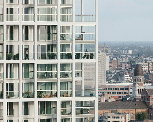 staggered white high-rise provides diverse adaptable housing in antwerp, belgium