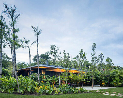 L-shaped weekend house by jacobsen arquitetura enjoys close connection to nature in são paulo