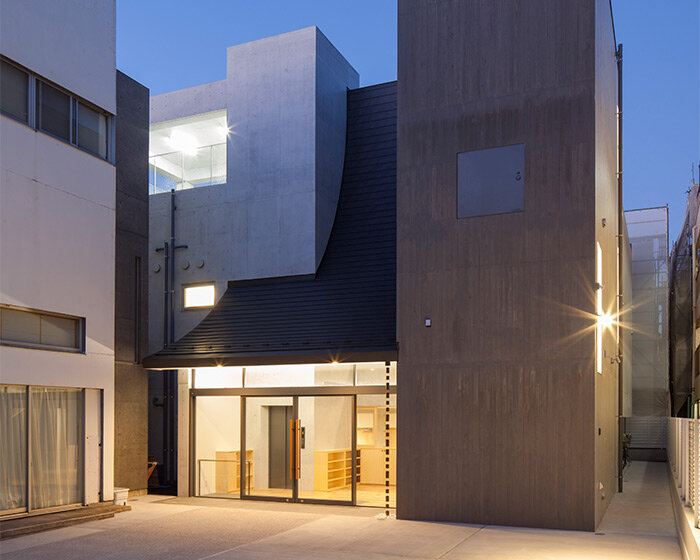 large curved roof welcomes visitors into reconstructed shinagawa branch temple in tokyo