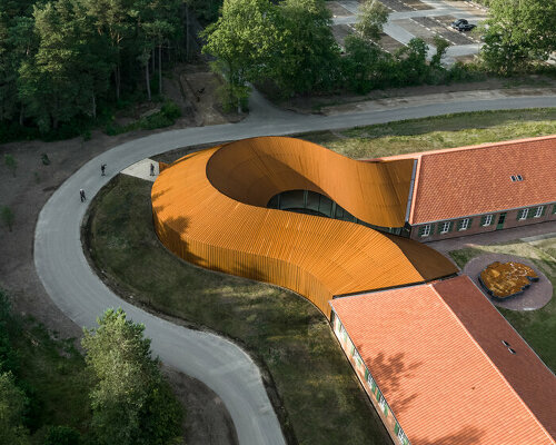 BIG adds a curved corten steel volume to new refugee museum of denmark