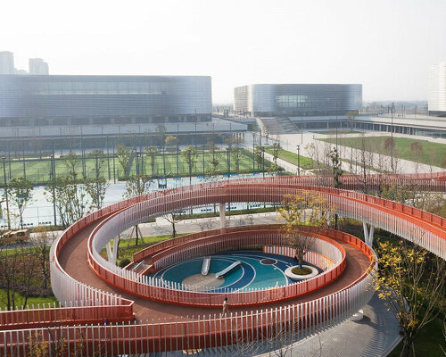 spiraling bright orange corridors wrap around playground in sichuan, china