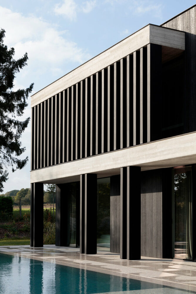 charred timber and nature surround JUMA’s villa in the flemish ardennes