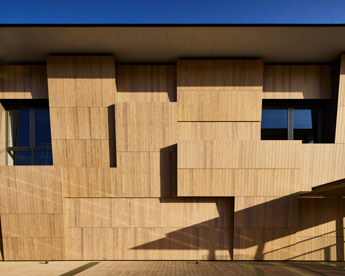 kengo kuma wraps yokohama campus building in a facade of folding timber panels