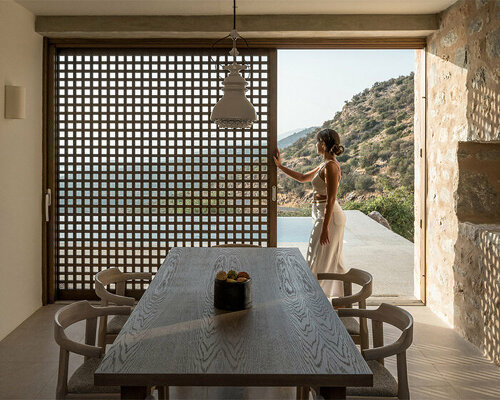 two lonely monolithic towers emerge from the rugged landscape of mani, greece