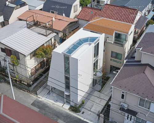 curved metal staircase slices through 'scoop landscape house' in tokyo