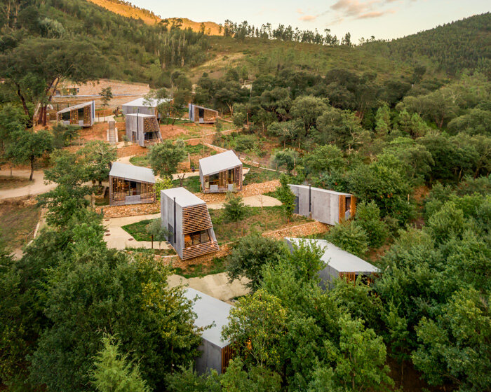 summary architecture scatters tiny hotel cabins over idyllic landscape of paradinha