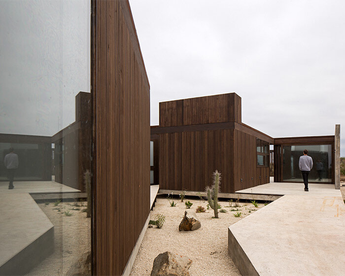 beach house by juan pablo ureta takes cues from rock clusters in chilean natural landscape