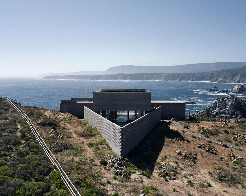 this cinder block 'LBS house' opens broadly over the coastal cliffs of chile