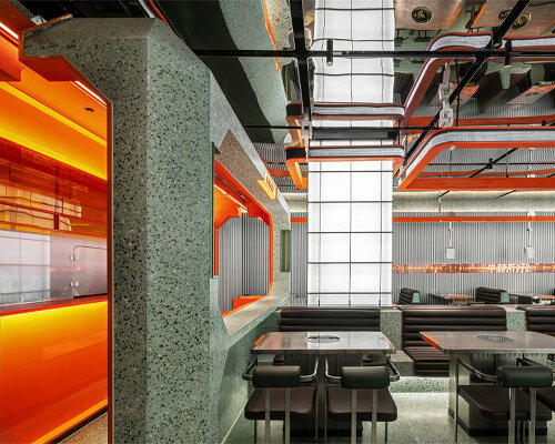 gray-green and bright orange tones collide within this futuristic dining spot in china