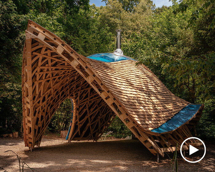 invisible studio teams with community members to sculpt parabolic shelter at westonbirt