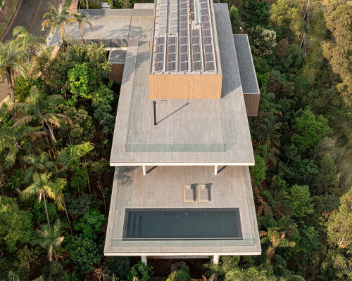 'minas house' by studio MK27 is a stilted concrete volume set amid a rainforest garden